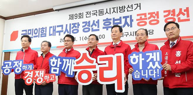 국민의힘 대구시장 경선 후보 6명과 컷오프(공천 배제)된 주호영 의원이 1일 대구 수성구 국민의힘 대구시당에서 열린 공정 경선 협약식에서 공정한 경쟁을 다짐하는 퍼포먼스를 하고 있다. 왼쪽부터 유영하·윤재옥·이재만·주호영·최은석·추경호·홍석준. /뉴시스
