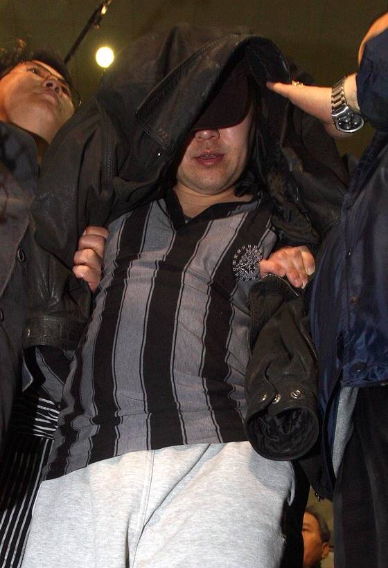 안양 초등학생 납치 살해범 정성현(당시 39세)이 2008년 3월 16일 밤 안양경찰서로 압송되고 있다. 중앙포토