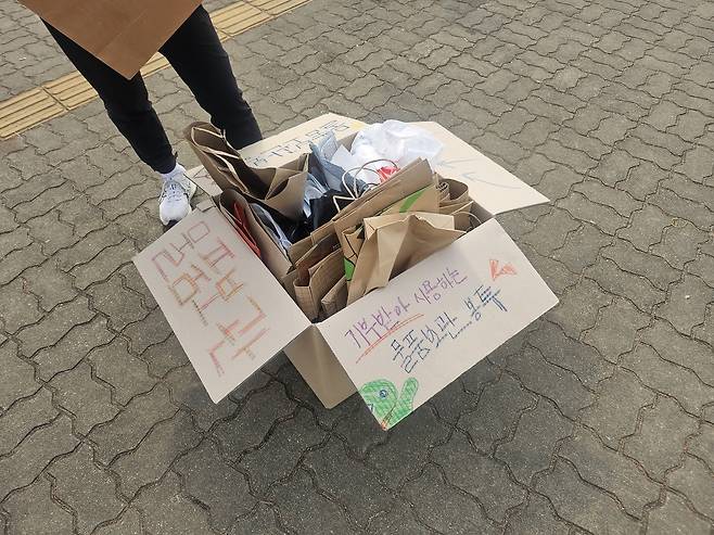 5일 오전 서울 마포 월드컵공원 평화광장에서 열린 ‘2026 무해런’에서 시민들이 종이봉투에 물품을 보관하고 있다. 김광우 기자.
