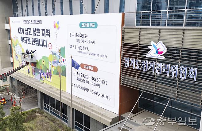 제9회 전국동시지방선거를 55일 앞둔 지난 9일 오전 수원시 영통구 경기도선거관리위원회에서 관계자들이 투표 참여 홍보 현수막을 설치하고 있다. 김경민기자