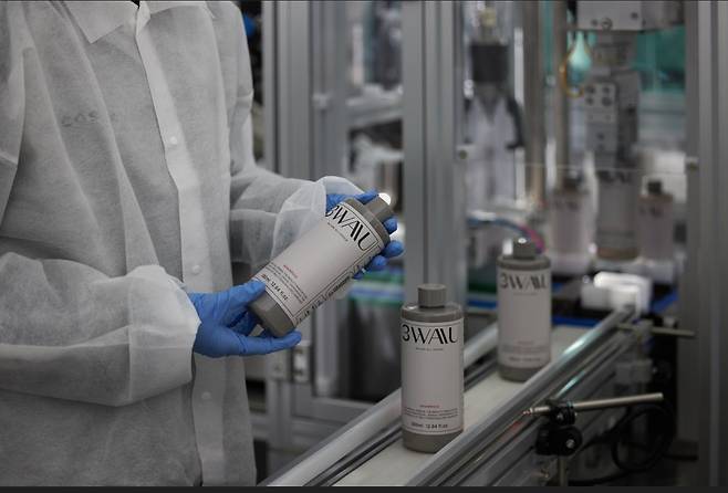 A person inspects a product made at Cosmax, a Korean cosmetic manufacturing company, in an undated photo. [COSMAX]
