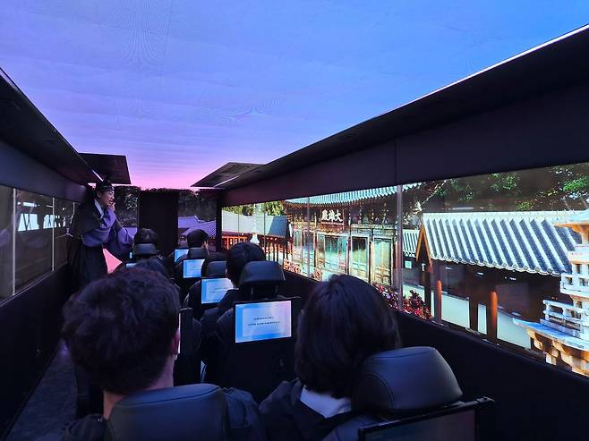 지난 17일 경북 경주시가 운영하는 '골든 신라 경주 XR 버스'에서 탑승객들이 실감형 XR 콘텐트를 감상하고 있다. 김정석 기자