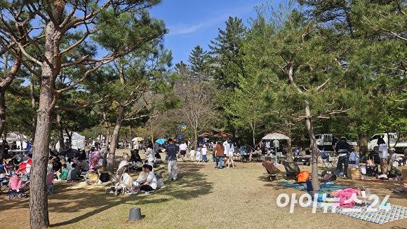 왕실축제 현장을 찾은 가족 단위 관람객들이 한낮 27도까지 오르는 무더위를 피하기 위해 턱없이 부족한 나무 그늘 아래로 몰려가 돗자리를 펴고 휴식을 취하고 있다. [사진=김재환기자]