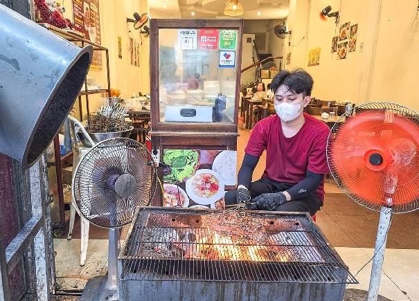 다낭의 분짜 식당에서 고기를 굽는 종업원[사진/이동경 기자]