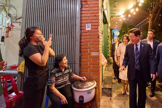 베트남을 국빈 방문중인 이재명 대통령과 김혜경 여사가 23일(현지시간) 저녁 베트남 하노이 도심 거리를 산책하고 있다. 청와대사진기자단