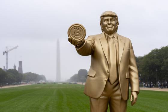 지난해 9월 미국 워싱턴 독립기념탑 앞 내셔널몰에 도널드 트럼프 대통령이 비트코인을 들고 있는 동상이 전시돼 있다. AP=연합뉴스