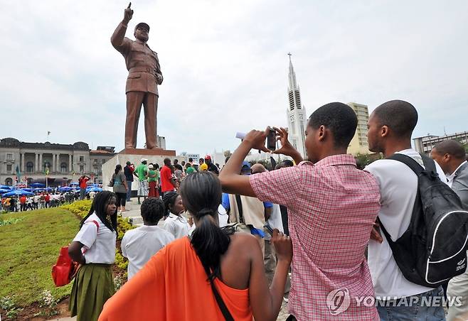 2011년 10월 19일 사모라 마셸 모잠비크 초대 대통령 25주기를 맞아 열린 동상 제막식에서 사진을 찍고 있는 주민들 [EPA 연합뉴스 자료사진. 재판매 및 DB 금지]