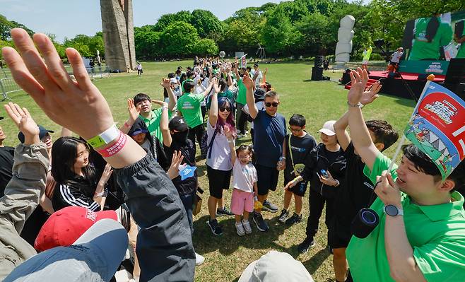 26일 서울 송파구 올림픽공원에서 열린 2026년 스포츠 주간 맞이 '땀송송 운동해봄제'에서 시민들이 '킹키와 함께 뛰는 응원봉런'에 앞서 손을 모아 응원하고 있다.