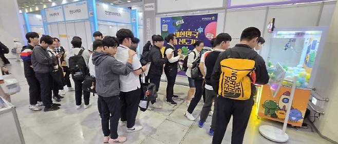 한국고용정보원 AI고용서비스 홍보관을 찾은 참가자들이 홍보이벤트와 기관 캐릭터 용용이와 온통청년 캐릭터 퓨와 기념촬연하고 있다. (사진제공=한국고용정보원)