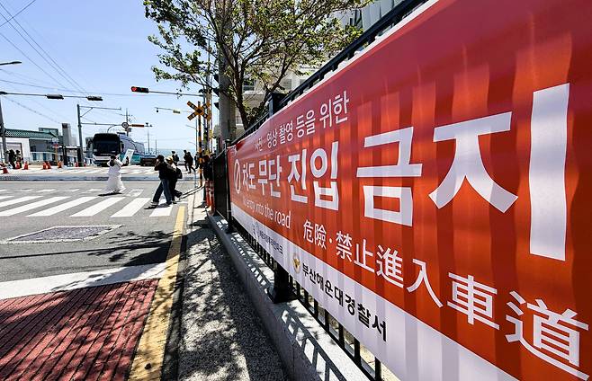16일 오전 부산 해운대구 청사포 횡단보도에 사진 촬영을 위한 도로 진입 금지를 알리는 현수막이 한국어,영어,중국어로 적혀 있다./김동환 기자
