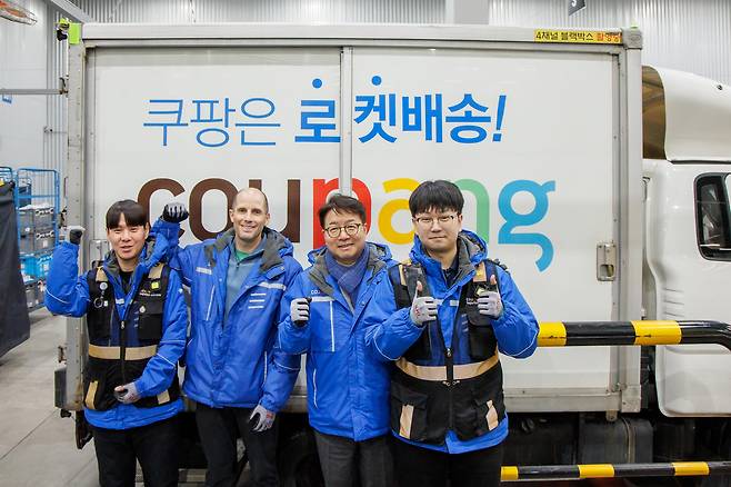 Harold Rogers, the interim chief of Coupang Korea, second from left, poses for a photograph during his delivery and preparation experiences in an undated photo. [COUPANG]