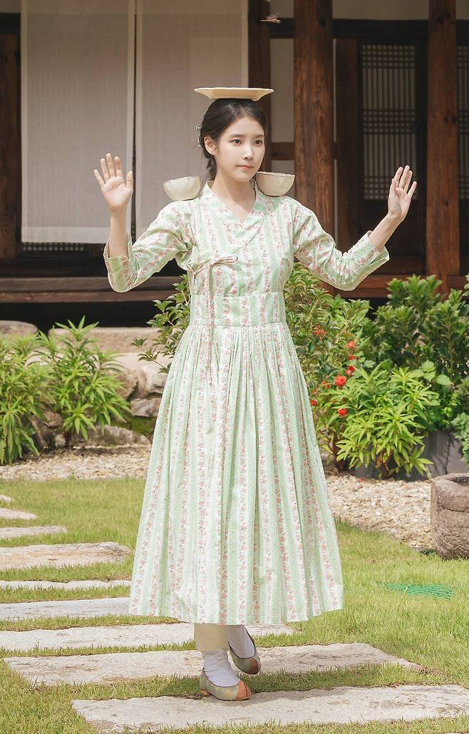 IU, as conglomerate heir Seong Hee-ju, wears a dress inspired by cheollik in the romantic comedy series ″Perfect Crown.″ [MBC]