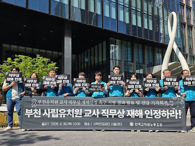 전국교직원노동조합이 지난달 30일 서울 여의도 사학연금공단 서울선테 앞에서 독감에도 근무하다 숨진 유치원 교사 A씨의 직무상 재해 인정을 촉구하고 있다. 사진 전교조