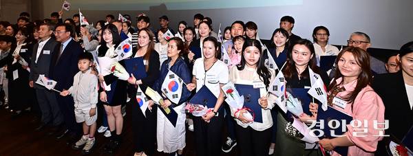 지난 8일 오후 인천 송도국제도시 인천도시역사관에서 열린 ‘대한민국 국적증서 수여식’에 참석한 국적 취득자와 가족들이 태극기를 들고 기념촬영을 하고 있다. 2026.5.8 /조재현기자 jhc@kyeongin.com