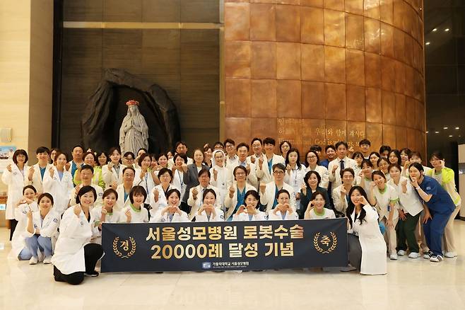 11일 오전 7시 30분 서울성모병원 본관 1층 로비 성당 앞에서 병원장 이지열 교수를 비롯한 여러 교직원이 기념사진을 촬영하고 있다.[서울성모병원 제공]