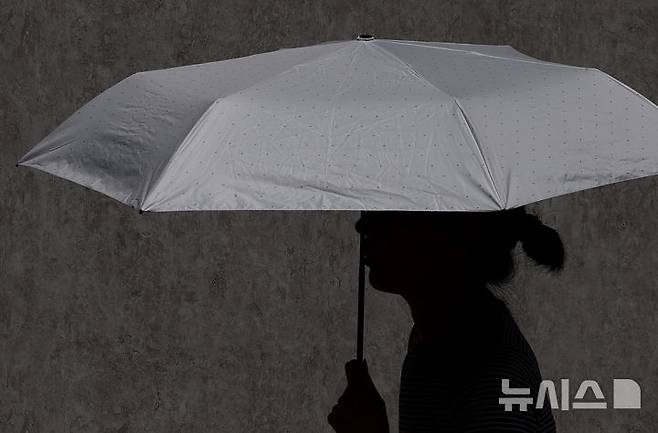 [대구=뉴시스] 이무열 기자 = 대구 낮 최고기온이 26도까지 오르며 초여름 날씨를 보인 11일 대구 중구 동성로에서 한 시민이 양산을 들고 이동하고 있다. 2026.05.11. lmy@newsis.com