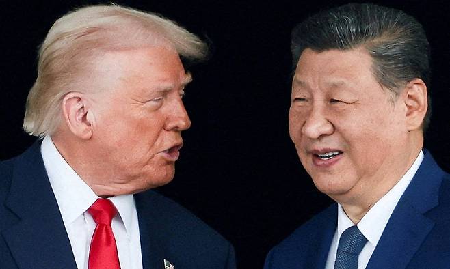FILE PHOTO: U.S. President Donald Trump and Chinese President Xi Jinping talk as they leave after a bilateral meeting at Gimhae International Airport, on the sidelines of the Asia-Pacific Economic Cooperation (APEC) summit, in Busan, South Korea, October 30, 2025. REUTERS/Evelyn Hockstein/File Photo