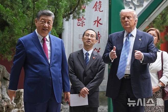 [베이징=AP/뉴시스] 도널드 트럼프(오른쪽) 미국 대통령이 15일(현지 시간) 중국 베이징 중난하이에서 시진핑 중국 국가주석과 함께 걷고 있다. 2026.05.15.