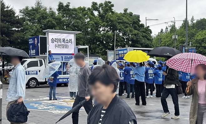 ▲ 더불어민주당 김남준 후보 출정식이 열린 21일 오전 인천 계양역 광장. 유세차 음악과 선거운동원들의 인사 속에 일부 시민들은 휴대전화로 현장을 촬영했고, 일부는 출근길 발걸음을 옮기고 있다.&nbsp;/김도엽 수습기자 ypypp@incheonilbo.com
