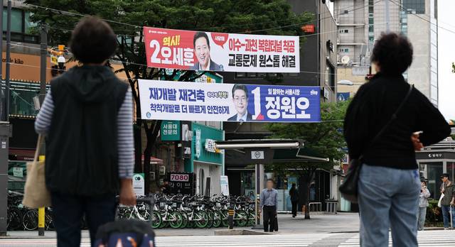 현수막 격돌  : 6·3 지방선거 공식 선거운동이 시작된 21일 서울 동작구 한 거리에 정원오 더불어민주당·오세훈 국민의힘 서울시장 후보의 공약이 담긴 현수막이 걸려 있다.  연합뉴스