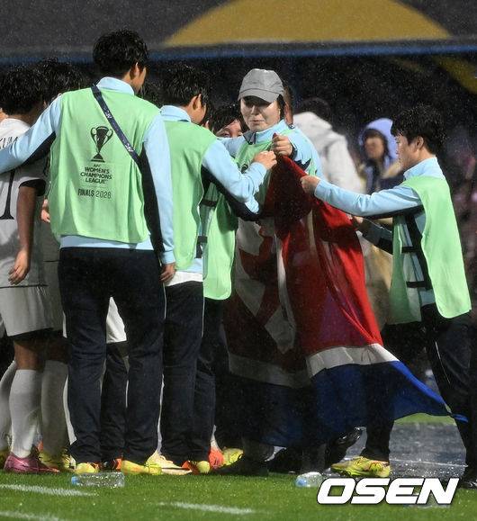 [OSEN=수원, 이대선 기자] 수원FC 위민은 20일 수원종합운동장에서 열린 2025-2026시즌 아시아축구연맹(AFC) 여자 챔피언스리그(AWCL) 4강전에서 북한 평양 내고향여자축구단과 경기에서 1-2로 패배했다.경기 종료 후 내고향여자축구단 선수단이 인공기를 펼치고 기념촬영을 하고 있다. 2026.05.20 /sunday@osen.co.kr