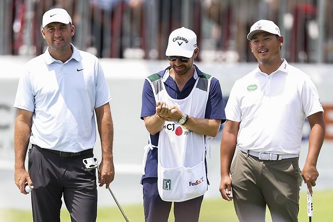 MCKINNEY, TEXAS - MAY 22: Scottie Scheffler of the United States and Si Woo Kim of South Korea react while playing the sixth hole during the second round of THE CJ CUP Byron Nelson 2026 at TPC Craig Ranch on May 22, 2026 in McKinney, Texas. (Photo by Mike Mulholland/Getty Images for The CJ Cup)