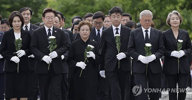 헌화대 향하는 이재명 대통령 (김해=연합뉴스) 김도훈 기자 = 이재명 대통령 부부, 권양숙 여사와 장남 건호 씨, 문재인 전 대통령 부부가 23일 경남 김해 봉하마을에서 열린 고 노무현 전 대통령 서거 17주기 추도식에서 국화를 들고 헌화대로 향하고 있다. 2026.5.23 [청와대통신사진기자단] superdoo82@yna.co.kr