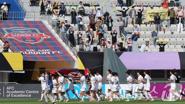 23일 오후 경기 수원시 수원종합운동장에서 열린 2025-2026 아시아축구연맹(AFC) 여자 챔피언스리그(AWCL) 결승 북한 내고향여자축구단과 도쿄 베르디의 경기에서 우승을 거둔 내고향 선수들이 인공기를 든 채 그라운드를 돌고 있다. /사진=뉴스1