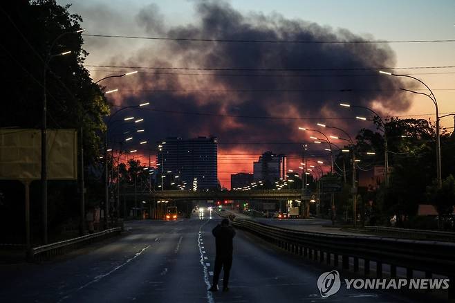 2일 우크라이나 키이우 시내에서 한 남성이 화염을 바라보는 모습 [로이터=연합뉴스. 재판매 및 DB 금지]