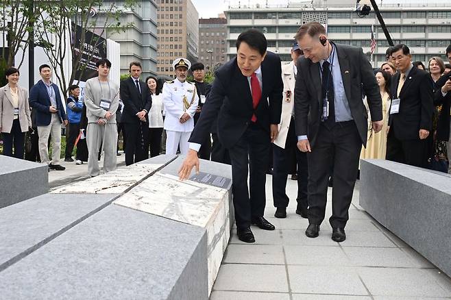 오세훈 국민의힘 서울시장 후보가 12일 서울 종로구 광화문광장에서 열린 '감사의 정원' 준공식에서 조형물을 살펴보고 있다. 공동취재