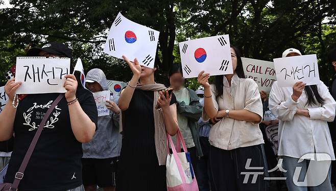 6·3 지방선거 투표용지 부족 사태에 반발한 시민들이 6일 오전 서울 송파구 올림픽공원 핸드볼경기장 개표소 앞에 모여 재선거를 요구하는 구호를 외치고 있다. 2026.6.6 ⓒ 뉴스1 구윤성 기자