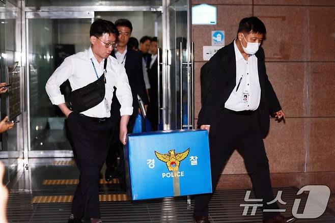 6·3 지방선거 투표용지 부족 사태를 수사하는 검경 합동수사본부 수사관들이 11일 서울 송파구선거관리위원회에 대한 압수수색을 마친 후 압수품 상자를 들고 이동하고 있다. [뉴스1]