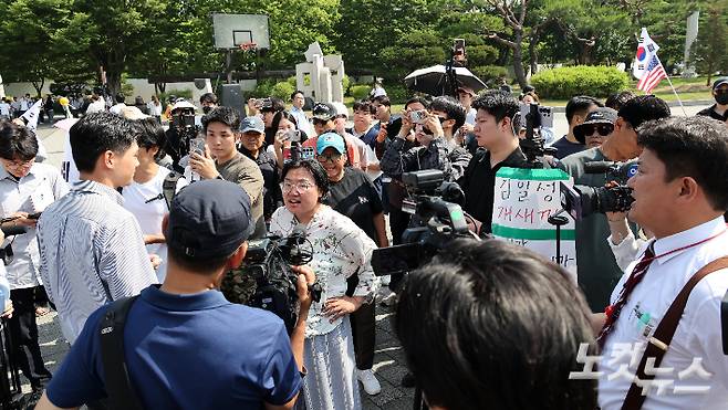 제9회 전국동시지방선거 투표용지 부족 사태에 대한 개표소 봉쇄 시위가 일주일째 이어지고 있는 11일 개표소로 이용됐던 서울 송파구 올림픽공원 핸드볼경기장 앞에서 시위대가 진보성향 언론사 취재진을 향해 비난을 쏟아내고 있다. 박종민 기자