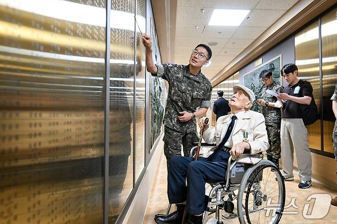 6·25전쟁 참전용사 한희나 옹이 육군본부 명예의 전당을 찾아 전쟁 당시 전우이자 상사였던 故 김병칠 이등상사의 이름을 확인하고 설명을 듣는 모습. 2026.6.22./ⓒ 뉴스1(육군 제공)