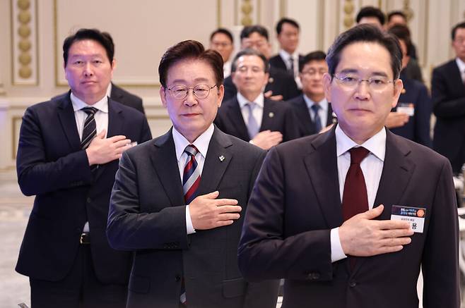 이재명&nbsp;대통령이 29일 청와대에서 열린 3대 메가프로젝트 국민보고회에서 국민의례를 하고 있다. 오른쪽부터 이재용 삼성전자 회장, 이 대통령, 최태원 SK그룹 회장. &copy;청와대통신사진기자단
