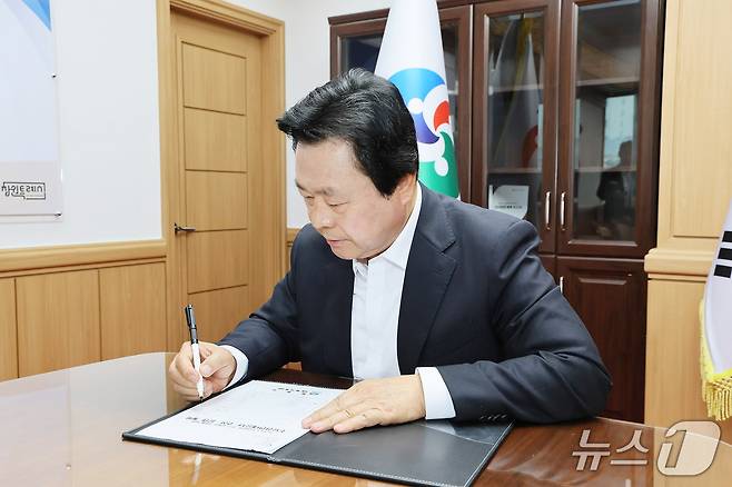 강기윤 경남 창원시장이 취임 첫날인 1일 시청 집무실에서 1호 결재로 '주요현안대응 TF 구성 및 운영 계획'에 서명하고 있다.(경남 창원시 제공. 재판매 및 DB금지)