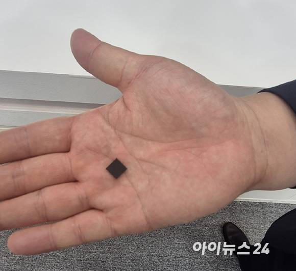 '퀀텀코리아 2026'에서 SKT 관계자가 양자칩을 손에 올려놓고 있다 [사진=서효빈 기자]