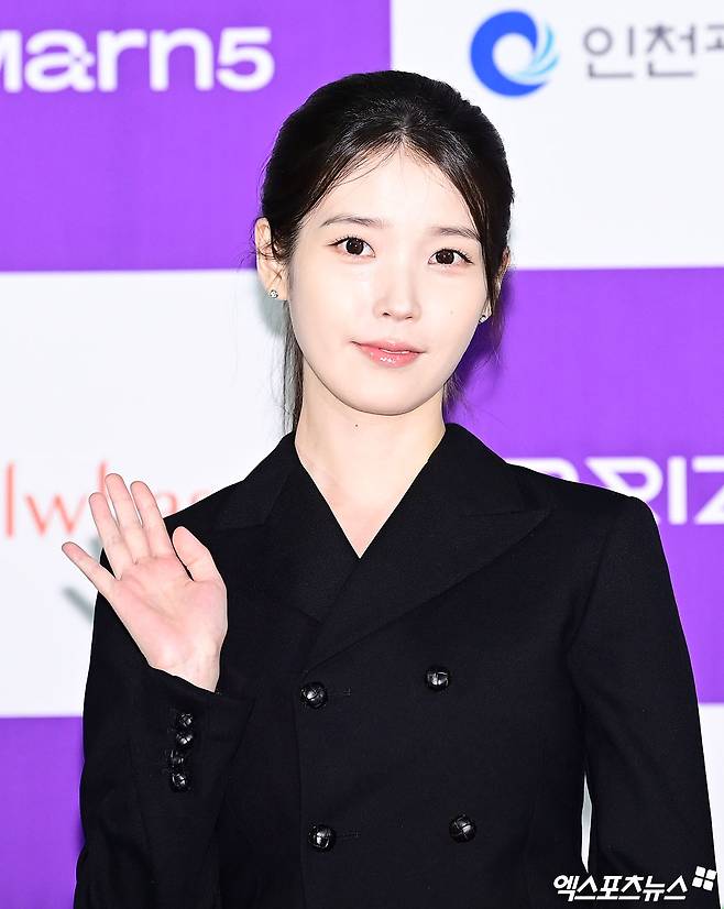 Singer and actress IU shared an official update on her activities for the first time in about two months by attending the handprinting ceremony for the 5th Blue Dragon Series Awards. IU appeared in a neat and polished look, wearing a black mini-jacket dress, delighting her fans.On the 7th, IU attended the handprinting event held at CGV Yongsan IPark Mall in Yongsan-gu, Seoul, where she posed for photos and shared a selfie. IU drew attention with her ponytail hairstyle and stylish outfit, and she sent a message of encouragement to her fans through her official account.This event drew particular attention as it marked IUs first public appearance in about two months following the controversy that arose last May. At the time, IU had posted an apology regarding the drama-related controversy.Fans expressed their delight at hearing from IU after such a long time and sent her enthusiastic support. They left comments on IUs social media posts, showing their unwavering affection and support.