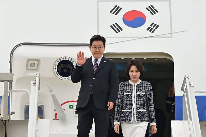 이재명 대통령과 김혜경 여사가 29일(현지시간) 칠레 산티아고 아르투로 메리노 베니테스 공항에 도착해 영접을 나온 환영 인사들에게 손인사를 하고 있다. 뉴스1