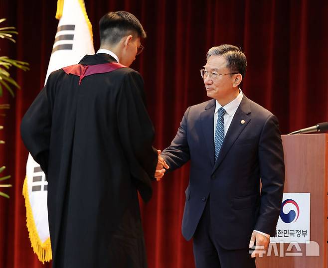 [과천=뉴시스] 김금보 기자 = 정성호 법무부 장관이 3일 오전 경기 과천시 정부과천청사에서 열린 신임검사 임관식에서 임명장을 수여하고 있다. 2026.08.03. kgb@newsis.com