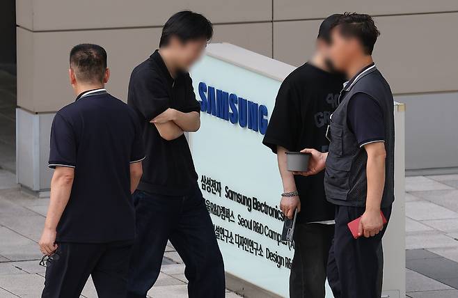 삼성전자 디바이스경험(DX) 부문 직원들이 지난 6월 성과급 격차에 항의하며 서울 서초구 우면동 삼성전자 서울R&D캠퍼스에 검은 옷을 입고 출근하고 있다. [연합]