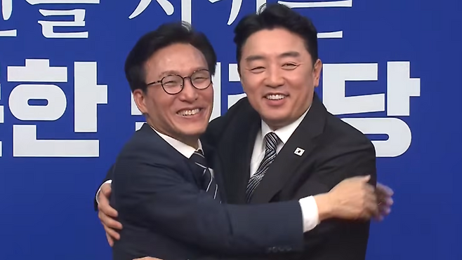 김민석 더불어민주당 신임 대표(왼쪽)가 18일 국회에서 이재명 대통령의 당선 축하난을 전달하기 위해 방문한 강훈식 대통령 비서실장과 포옹하고 있다. (델리민주)