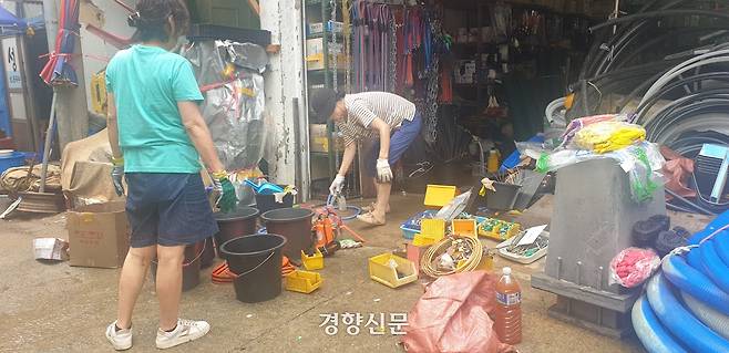 18일 경남 통영시 서호동 서호전통시장 한 철물가게 주인이 침수된 물품과 가게를 정리하고 있다. 김정훈 기자