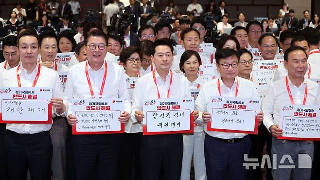 [고양=뉴시스] 최진석 기자 = 장동혁 국민의힘 대표와 정점식 원내대표를 비롯한 의원들이 27일 경기 고양시 소노캄 고양에서 열린 2026 국민의힘 국회의원 연찬회에서 슬로건 제창 및 피켓 퍼포먼스를 하고 있다. 2026.08.27. myjs@newsis.com