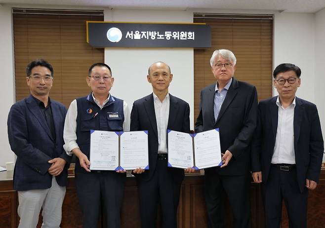 < 서울 시내버스 노사협상 극적 타결 > 16일 서울 영등포구 서울지방노동위원회에서 열린 버스노조의 노동 쟁의 관련 분쟁에 대한 조정 회의에서 김정환 서울시버스운송조합 이사장(오른쪽 두번째)과 박점곤 서울시버스노조 위원장(왼쪽 두번째)이 조정안에 서명한 뒤 기념촬영을 하고 있다. 사진=연합뉴스
