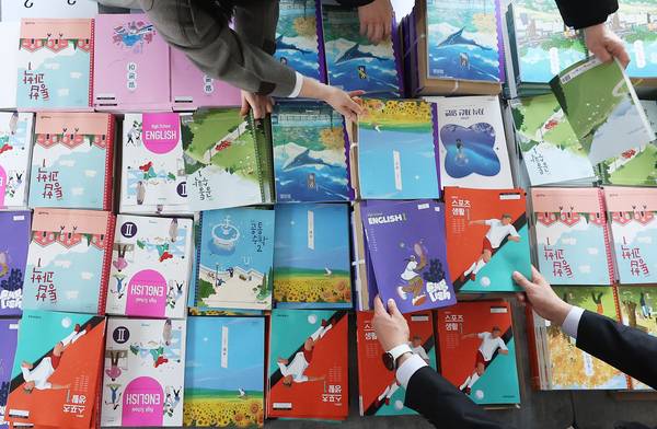 수원 한 고등학교 교직원들이 새 학기 교과서 배부 준비작업을 하고 있다. /연합뉴스