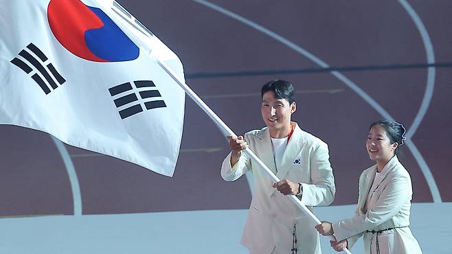 19일 일본 나고야 미즈호공원 육상경기장에서 열린 2026 아이치·나고야 아시안게임 개회식에서 한국 선수단 기수로 선정된 조정 김동용과 탁구 신유빈이 태극기를 들고 입장하고 있다. /연합뉴스