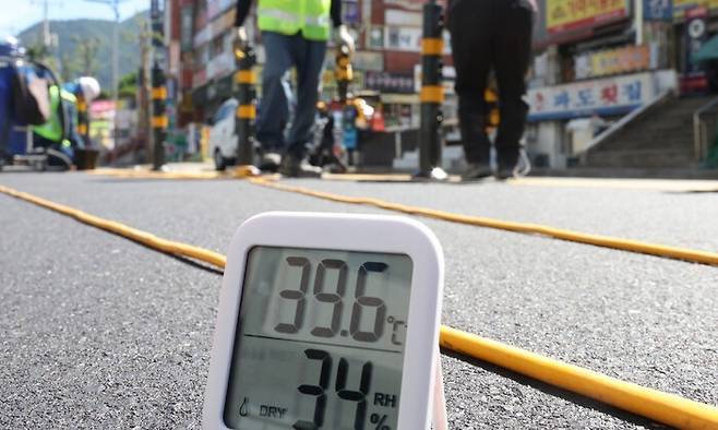경남 창원시에 폭염중대경보가 내려진 지난 7월31일 시내 한 도로 공사 현장에서 작업자들이 중앙분리대 설치 작업을 하고 있다. 연합뉴스