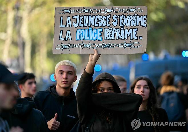 '청년의 외침, 경찰의 탄압'이라고 쓰인 플래카드 든 시위자 [AFP=연합뉴스 자료사진. 재판매 및 DB 금지]