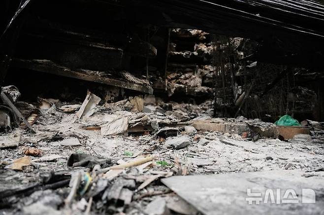 [파리=AP/뉴시스] 22일(현지시간) 프랑스 일간 르파리지앵에 따르면 장디디에 베르제 내무부 차관은 이날 쉬드라디오에 출연해 "목표는 가용한 모든 병력을 동원하는 것"이라고 밝혔다. 사진은 지난 21일(현지 시간) 프랑스 파리의 한 신문 가판대에 불에 탄 물건들이 남아 있는 모습. 지난 주말 프랑스 전역에서는 생활비 상승에 항의하는 시위가 폭동과 약탈로 번졌다. 2026.10.23.